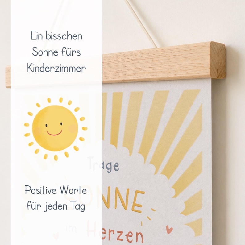 May include: A cheerful, framed print with a smiling yellow sun illustration and the words "Positive Words for Every Day." The print is held by a natural wood frame and a string for hanging. The text "Ein bisschen Sonne f&uuml;rs Kinderzimmer" is also visible.