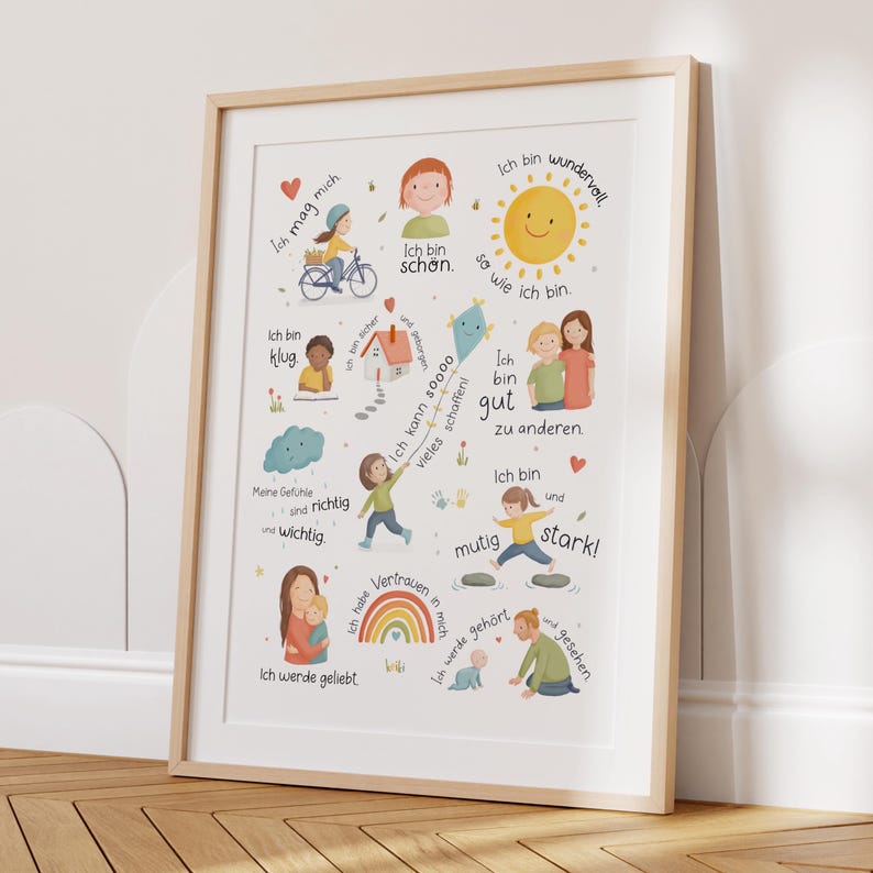 May include: A framed print with a light wood frame. The print features colorful illustrations of people, a sun, and a rainbow, along with German text. The text includes phrases like "Ich bin gut" and "Ich mag mich". The overall theme is positive affirmations.