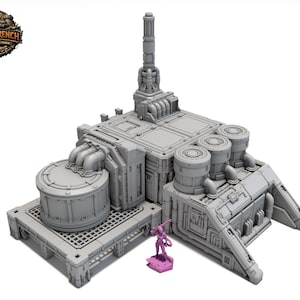 May include: A grey, futuristic building with multiple cylindrical tanks and a tall, central structure. A small, pink figurine stands nearby. The building has a detailed, industrial design, with pipes and grates.