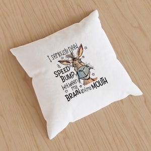 May include: White throw pillow with a cartoon donkey and the text "I seriously need a speed bump between my brain and my mouth".