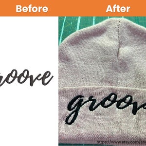 May include: A close-up of a pink beanie with the word "groove" embroidered in black thread. The word is in a cursive font.