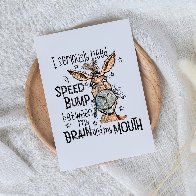 May include: A white card with a cartoon donkey and the text "I seriously need a speed bump between my brain and my mouth".