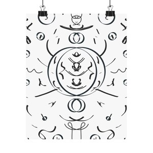 May include: A white poster with a symmetrical black ink design. The artwork features abstract shapes, including circles, lines, and organic forms, creating a balanced and visually engaging composition. The poster is held by two black binder clips.
