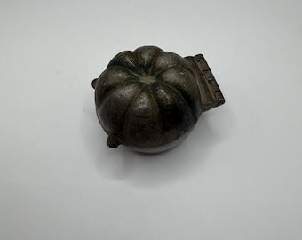 A metal vintage icecream mould, in the shape of orange segments