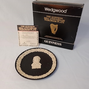 May include: A black and white Wedgwood commemorative plate celebrating the 225th anniversary of Guinness. The plate features a portrait of Arthur Guinness, the founder of the brewery, and the text "The Guinness 225th Anniversary Wedgwood Plate".