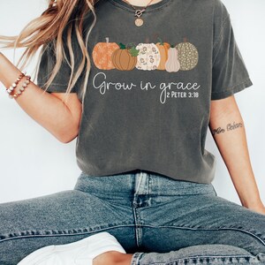 May include: A gray t-shirt with a row of five colorful pumpkins and the text "Grow in grace 2 Peter 3:18".