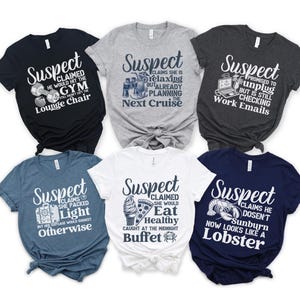 May include: Six different t-shirts with a blue and white design. Each shirt has the word "Suspect" and a humorous saying about holiday. The shirts are on a white background.