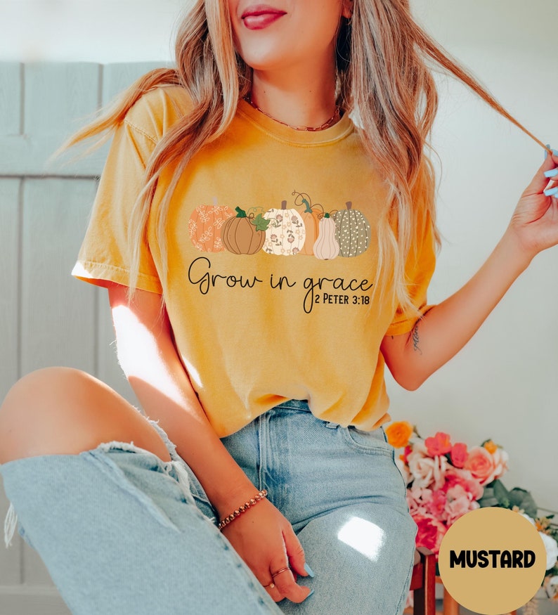 May include: A mustard yellow t-shirt with a graphic of pumpkins and the text "Grow in grace 2 Peter 3:18".