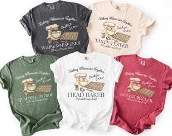 Peut inclure: Cinq t-shirts à manches courtes de couleurs variées : charbon, crème, blanc, rouge et vert. Chaque t-shirt présente un graphisme sur le thème de la pâtisserie avec un mixeur, des biscuits et du texte.