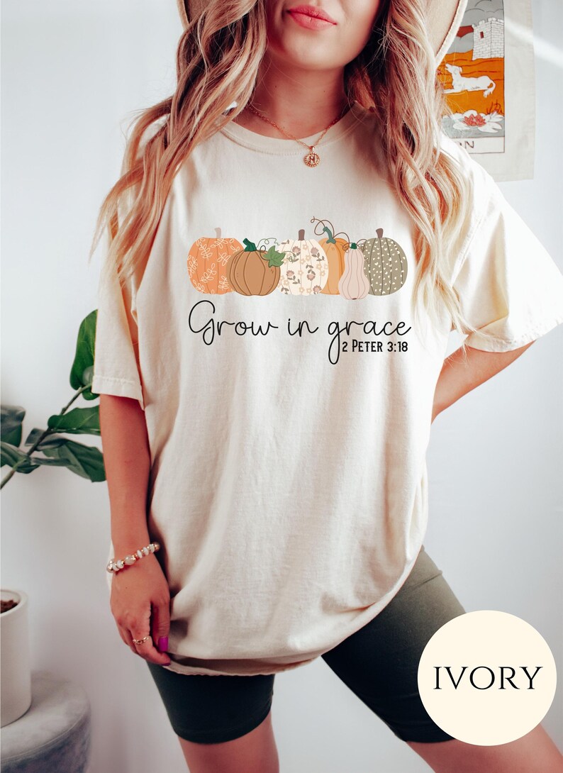 May include: A cream colored t-shirt with a graphic of pumpkins and the text "Grow in grace 2 Peter 3:18".