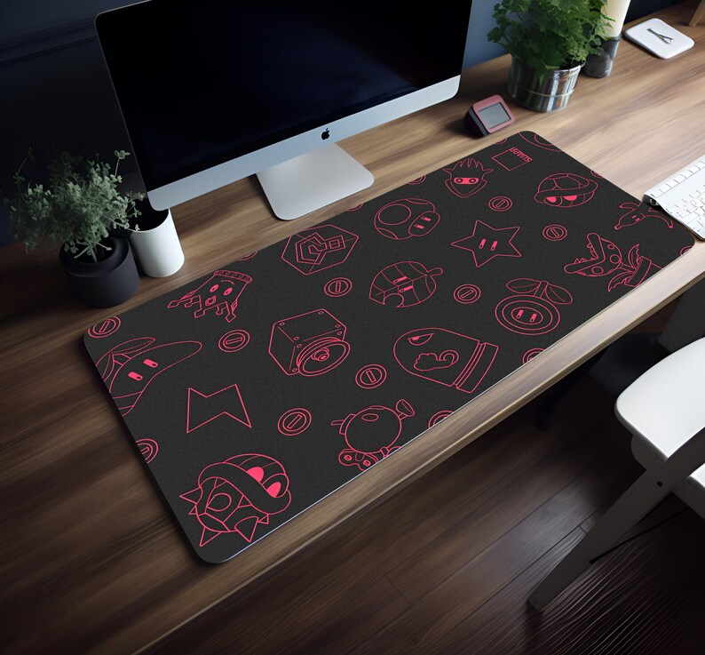 May include: A black gaming mouse pad with a pink outline of various video game characters and symbols. The mouse pad is on a wooden desk.