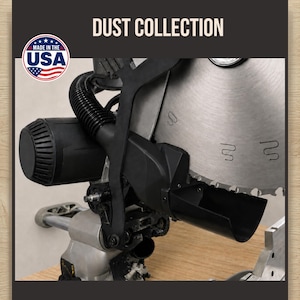 May include: A black plastic dust collection attachment for a miter saw, featuring a flexible hose and a wide collection chute positioned near a large circular metal saw blade. The text DUST COLLECTION and a MADE IN THE USA circular logo are visible.