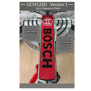 May include: A red and black Bosch GCM12SD Version 1 zero clearance plate for a mitre saw. The plate features the Bosch logo and text stating: Check your screw hole locations on version one - the screws are located 4 inches from the edge of the plate.