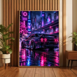 May include: A framed wall art print depicting a dark sports car parked on a wet city street at night. The scene is illuminated by vibrant neon pink and blue lights reflecting off the pavement, with a towering cityscape in the background.