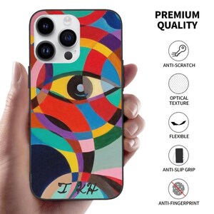 May include: A colorful phone case featuring an abstract eye design with red, yellow, blue, and purple shapes. The case is held in a hand and has the text "I KH" at the bottom. The image also includes the text "PREMIUM QUALITY".