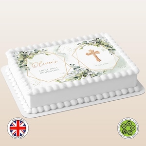 Peut inclure: Un gâteau rectangulaire blanc décoré pour une première communion. Le gâteau présente une croix dorée et un motif floral, avec le nom "Oliver's" et le texte "First Holy Communion". Le gâteau est décoré de glaçage blanc et d'un bord festonné.