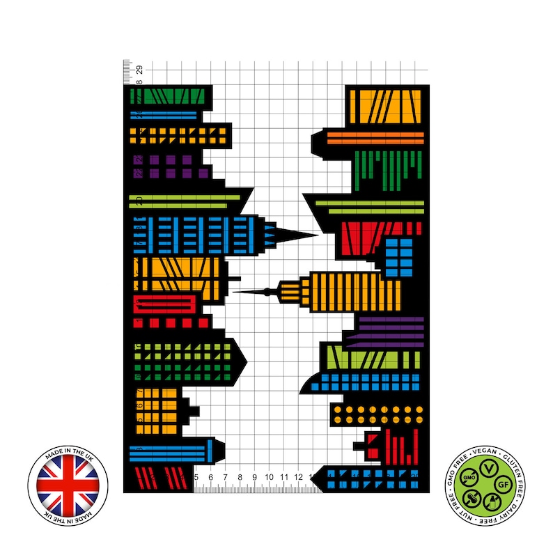 Sheet showing a black city skyline design with colourful red, blue, green, purple, and yellow windows, displayed on a 1cm grid with Made in the UK and vegan, gluten-free, nut-free, dairy-free, GMO-free certification icons.