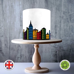 Sheet showing a black city skyline design with colourful red, blue, green, purple, and yellow windows, displayed on a 1cm grid with Made in the UK and vegan, gluten-free, nut-free, dairy-free, GMO-free certification icons.