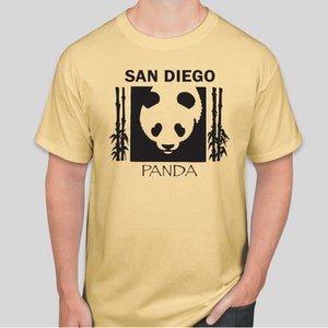 May include: A yellow t-shirt with a black graphic of a panda bear's face in a square with the text "SAN DIEGO" above and "PANDA" below the image.