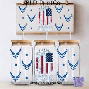 May include: A set of three glass tumblers with wooden lids and straws, featuring blue Air Force emblems and stars. The design includes a wooden sign with the text "UNITED STATES AIR FORCE" and an American flag design.