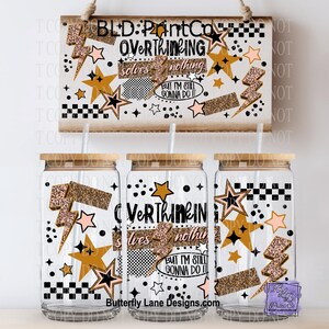 May include: Three clear glass tumblers with bamboo lids and straws, decorated with stars, lightning bolts, and the text "Overthinking solves nothing but I'm still gonna do it." A wooden sign above repeats the design.