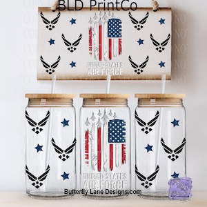 May include: Clear glass tumblers with wooden lids and straws, featuring a distressed American flag design and United States Air Force text. The design includes Air Force emblems and blue stars. A wooden sign with the same design hangs above.