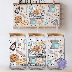 May include: Three glass tumblers with wooden lids and straws, decorated with baking-themed illustrations. The design includes images of a mixer, cookies, vanilla extract, and the text "Baking is my therapy". A wooden sign with the same design hangs above.