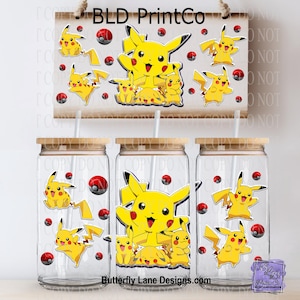May include: Three clear glass tumblers with wooden lids and straws, decorated with yellow Pikachu characters and red and white Poké Balls. A wooden sign above features the same design, with the text "BLD PrintCo". The text "Butterfly Lane Designs.com" is also visible.
