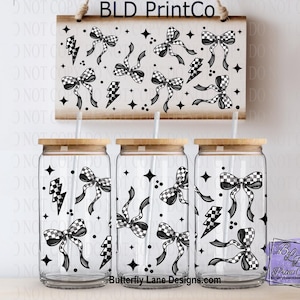 May include: Three glass tumblers with wooden lids and straws, decorated with black and white checkered bows, lightning bolts, and stars. A matching sign hangs above. The sign and tumblers have the text "BLD PrintCo" and "Butterfly Lane Designs.com".