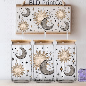 May include: Three clear glass tumblers with bamboo lids and straws, featuring celestial designs of the sun, moon, and stars. A wooden sign above repeats the design. The text "BLD PrintCo" is at the top, and "Butterfly Lane Designs.com" is at the bottom.
