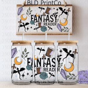 May include: Clear glass beverage cups with wooden lids, decorated with fantasy-themed illustrations. The design includes a sign with the text "FANTASY READER", along with moons, crystals, and bats. A small card with the logo "BLD PrintCo" is also visible.