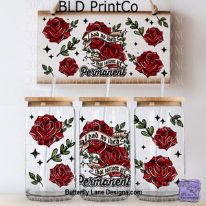 May include: Clear glass tumblers with bamboo lids, featuring a red rose and banner design with the text "I had no idea that tattoos are permanent." A matching wooden sign hangs above.