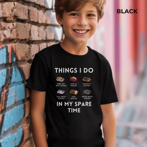 May include: A black short-sleeve t-shirt featuring the white text THINGS I DO IN MY SPARE TIME and six small illustrations of isopods with the captions HANG OUT WITH ISOPODS, LOOK AT ISOPODS, RESEARCH ISOPODS, TALK ABOUT ISOPODS, FEED ISOPODS, DREAM ABOUT ISOPODS.
