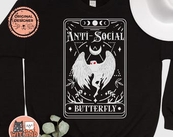 May include: Black sweatshirt with a white graphic of a creature with wings and the text "Anti-Social Butterfly".