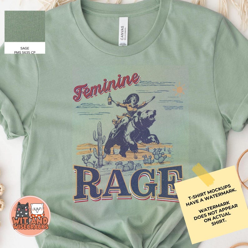 May include: Sage green t-shirt with a vintage-style graphic of a woman riding a bear with the text "Feminine Rage".