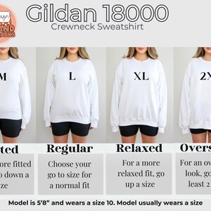 May include: A size chart for Gildan 18000 crewneck sweatshirts. The chart shows four different sizes: M, L, XL, and 2XL. Each size is represented by a white sweatshirt worn by a model. The chart also includes descriptions of the fit for each size: Fitted, Regular, Relaxed, and Oversized.