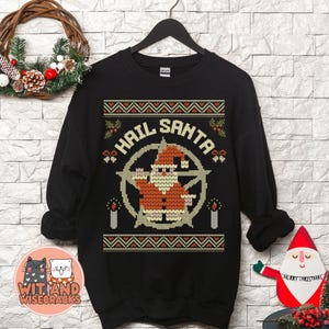 May include: Black Christmas sweater with a white and red Santa Claus design. The sweater has the words "Hail Santa" in a circle with a pentagram inside.