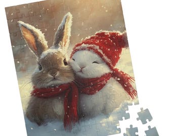 May include: A completed jigsaw puzzle featuring two rabbits in a snowy scene. One rabbit is brown, the other white, both wearing red scarves. The white rabbit wears a red hat. Snowflakes fall in the background. A few puzzle pieces are separate.