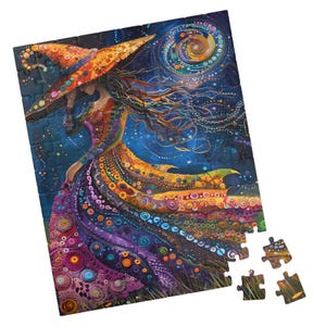 May include: A colorful jigsaw puzzle featuring a woman in a flowing dress and a large hat, set against a starry night sky with a crescent moon. The puzzle has a whimsical, artistic style with vibrant colors and intricate patterns. Several puzzle pieces are separate.