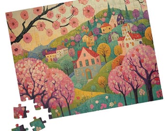 May include: A colourful jigsaw puzzle showing a whimsical village nestled amongst lush green hills and blooming pink trees. The puzzle pieces are scattered around the completed image.
