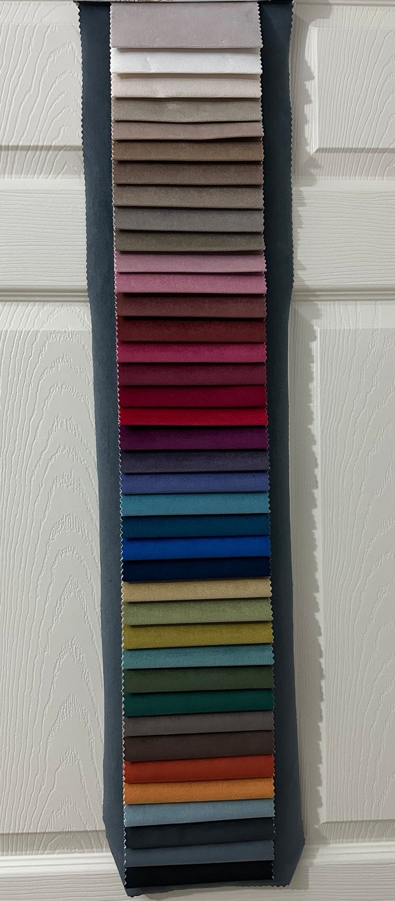 May include: A fabric swatch book with 20 different fabric samples in various colors, including white, beige, pink, red, blue, green, brown, and gray.