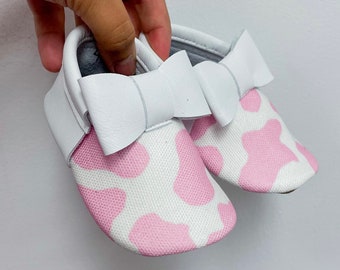 Pink Cow Pattern Baby Bow Moccasins  - Adorable Animal Print Shoes for Infants and Toddlers. Soft Sole Shoes
