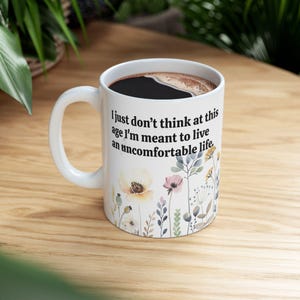 I just don&#39;t think at this age I&#39;m meant to live an uncomfortable life - Victoria Ratliff White Lotus quotes flower mug, double-sided