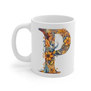 Può includere: Tazza in ceramica bianca con un design floreale della lettera "P". La lettera è decorata con fiori e foglie arancioni, gialli e blu. La tazza ha un manico standard e una finitura lucida, adatta per bevande calde o fredde.
