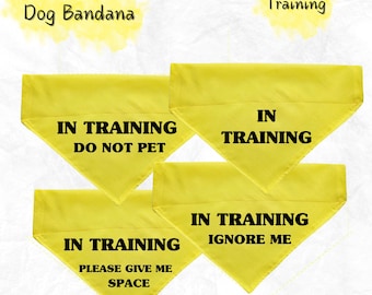 May include: Yellow dog bandanas with black text that reads "IN TRAINING." One bandana says "DO NOT PET," another says "IGNORE ME," and a third says "PLEASE GIVE ME SPACE." The words "Over The Collar Dog Bandana" and "Training" are also visible.