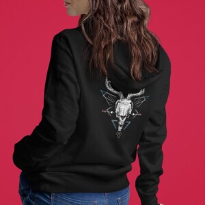 May include: Black hooded sweatshirt with a white graphic of an animal skull with antlers inside a geometric design.