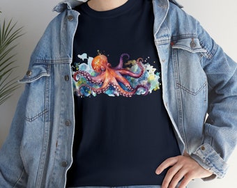 May include: A navy blue t-shirt featuring a watercolour design of an octopus with orange and pink tentacles. The octopus is surrounded by colourful watercolour splatters.