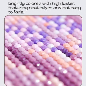 May include: Close-up of a diamond painting with small, round, iridescent purple, pink, and white rhinestones. The rhinestones are arranged in rows and create a gradient effect.