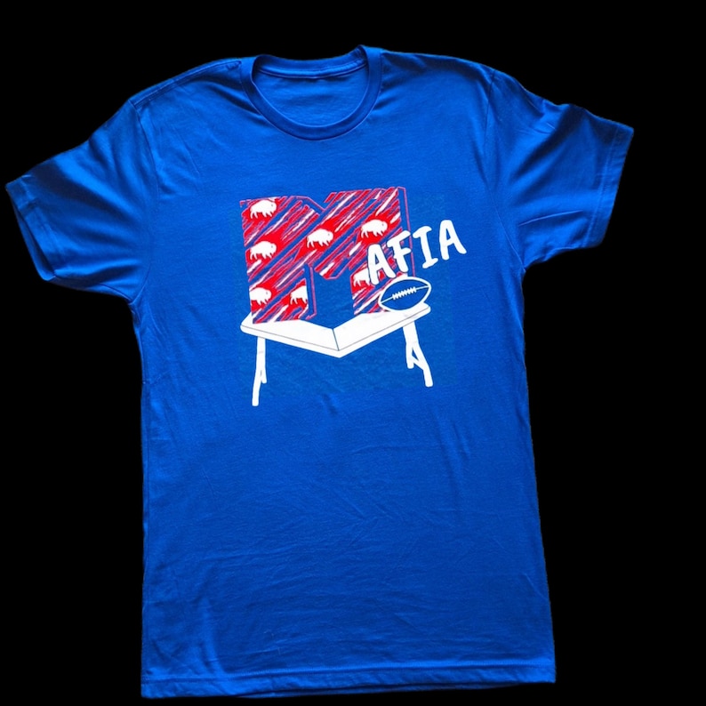 Buffalo Bills Mafia custom t shirt.  Mtv influenced, letter M crashing on top of table.  Royal blue color shirt. Next Level branded tee.