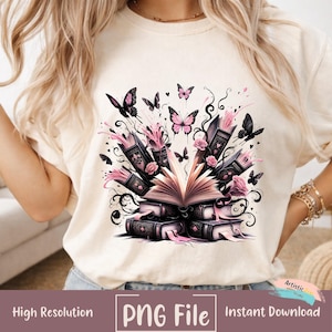 Pode incluir: Camiseta creme com um design gráfico de livros, rosas e borboletas. O design inclui um livro aberto com páginas rosa, borboletas pretas e o texto "PNG File" e "Instant Download".